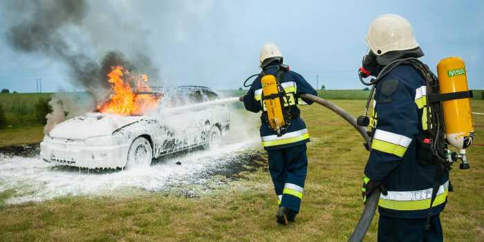 firefighters extinguishing a car fire
